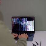 Why Is My Website Down? How to Check and What to Do 8 Person troubleshooting a website issue on a laptop screen