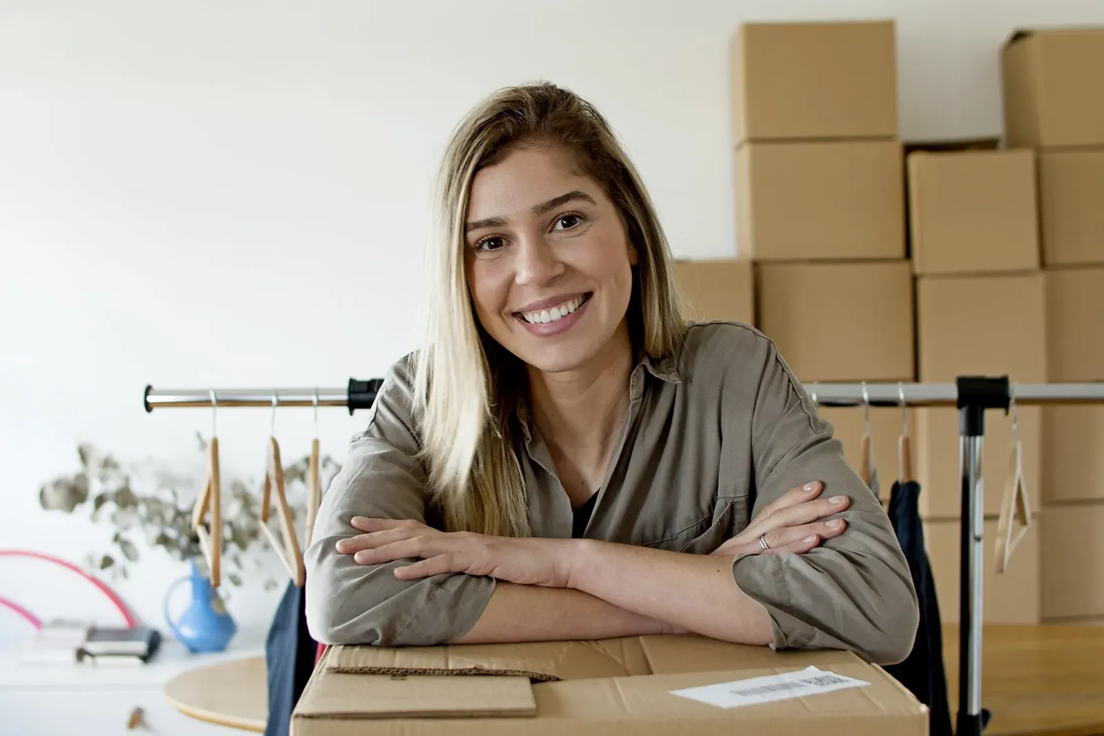 An online shop owner smiling among her parcels